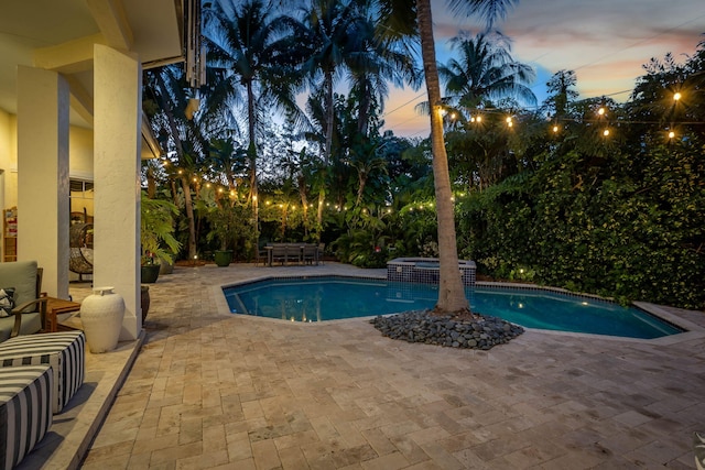 2409 NE 12th St, Fort Lauderdale, FL 33304 - pool at dusk with a pool with connected hot tub and a patio
