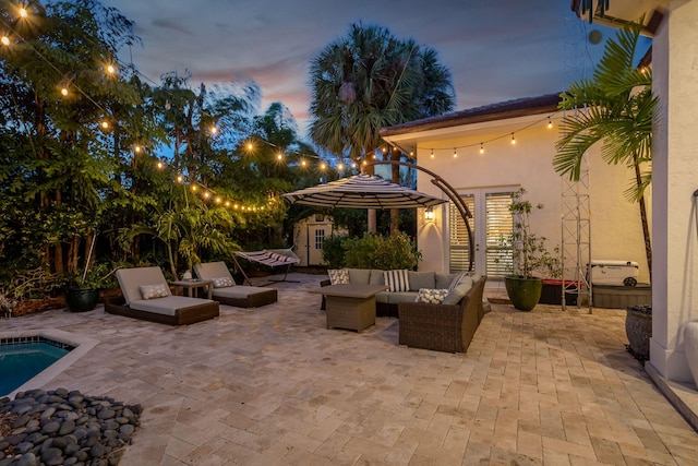 2409 NE 12th St, Fort Lauderdale, FL 33304 - patio terrace at dusk featuring a storage shed, an outdoor pool, an outdoor structure, and an outdoor living space