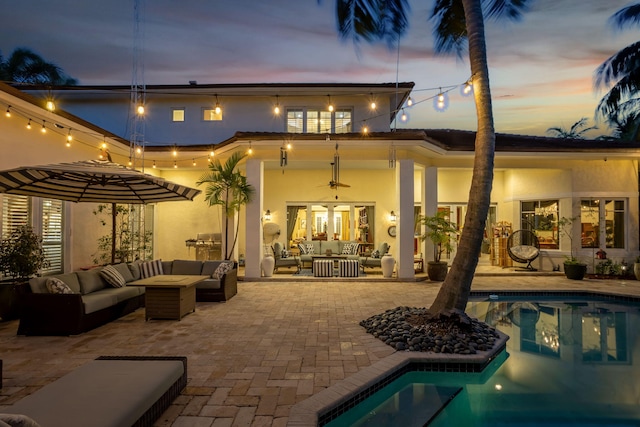 2409 NE 12th St, Fort Lauderdale, FL 33304 - rear view of house featuring stucco siding, a patio, and an outdoor hangout area
