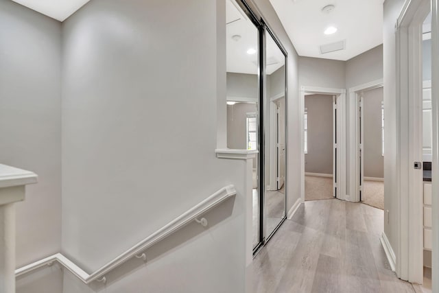 3216 W Community Dr, Jupiter, FL 33458 - hall with light wood finished floors, baseboards, and an upstairs landing