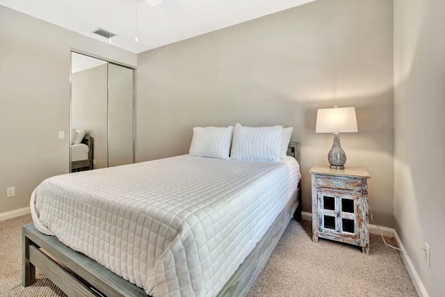 3216 W Community Dr, Jupiter, FL 33458 - bedroom with light colored carpet, baseboards, and a closet