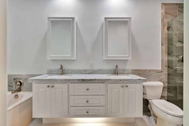 3216 W Community Dr, Jupiter, FL 33458 - bathroom featuring double vanity, toilet, a shower stall, tile walls, and a garden tub