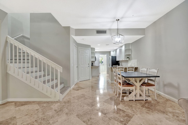 3216 W Community Dr, Jupiter, FL 33458 - dining room with stairs, baseboards, and a chandelier