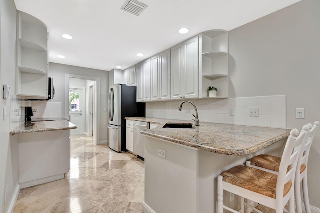 3216 W Community Dr, Jupiter, FL 33458 - kitchen featuring open shelves, stainless steel appliances, a sink, decorative backsplash, and recessed lighting