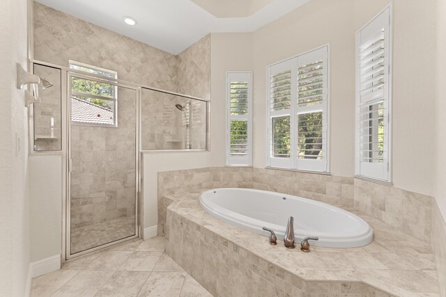 full bath with a bath, tile patterned floors, and a shower stall