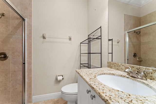 full bath with toilet, baseboards, a shower stall, a textured wall, and vanity