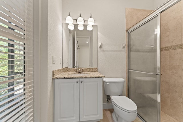 full bathroom with toilet, a textured wall, vanity, and a stall shower