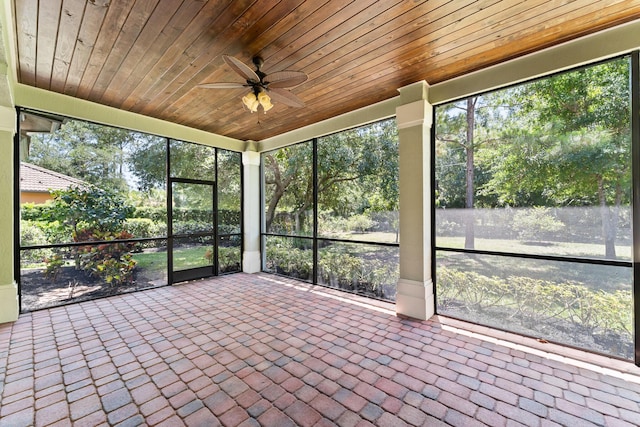 unfurnished sunroom featuring a ceiling fan