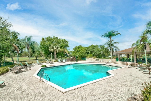 pool with fence, a gazebo, and a patio