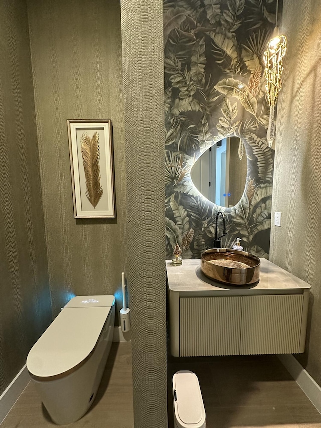5214 SW Pomegranate Way, Palm City, FL 34990 - bathroom with wallpapered walls, toilet, and wood finished floors