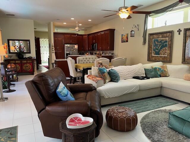 living room with a ceiling fan, light tile patterned flooring, and recessed lighting