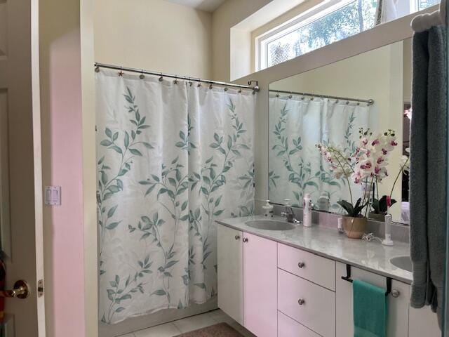 full bath featuring tile patterned flooring, a sink, and double vanity
