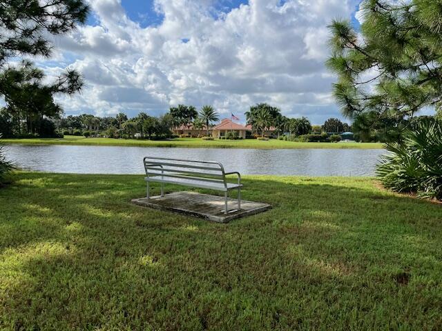 surrounding community featuring a yard and a water view
