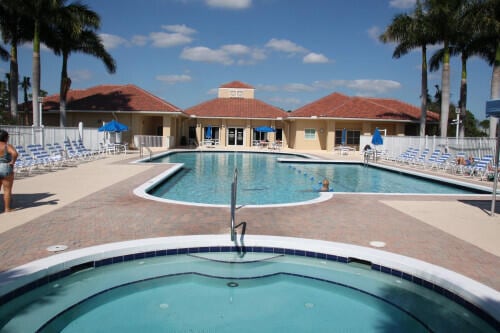 community pool featuring fence and a patio area