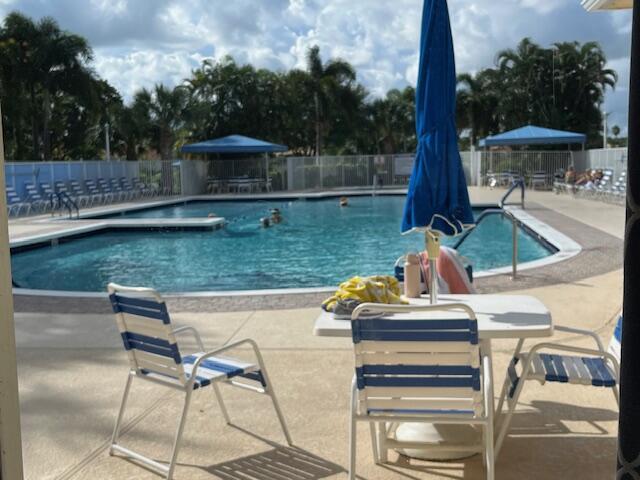 community pool featuring a patio and fence