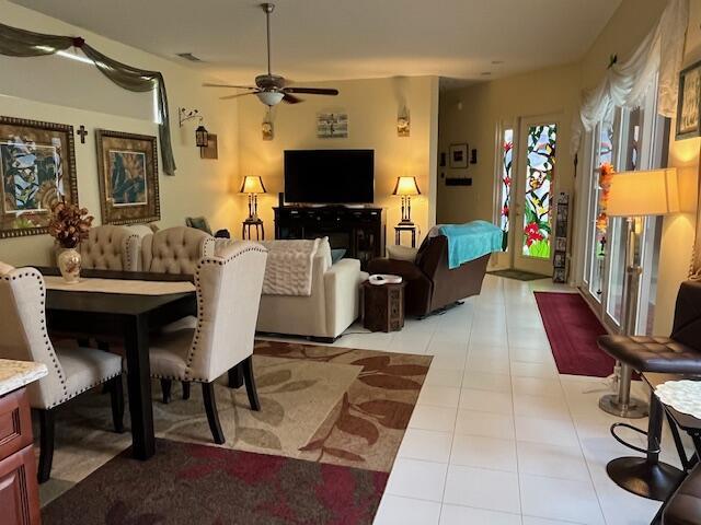 living room featuring light tile patterned flooring and a ceiling fan