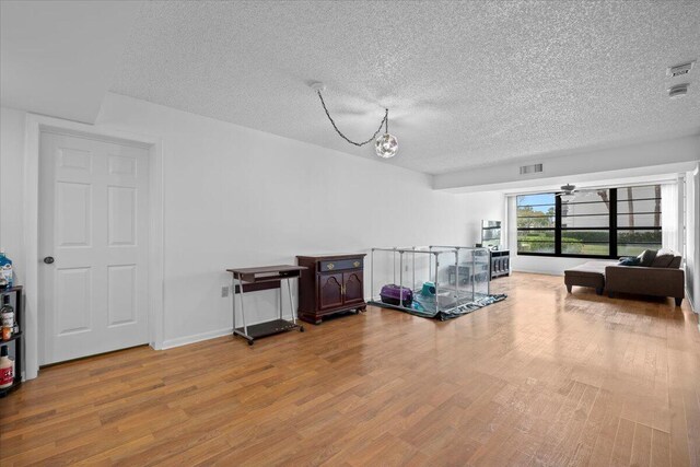 3526 Whitehall Dr Unit 106, West Palm Beach, FL 33401 - sitting room featuring wood finished floors and a textured ceiling