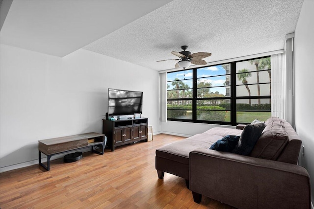 3526 Whitehall Dr Unit 106, West Palm Beach, FL 33401 - living room with a ceiling fan, light wood finished floors, a textured ceiling, and baseboards