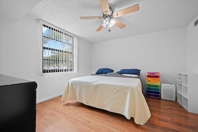 3526 Whitehall Dr Unit 106, West Palm Beach, FL 33401 - bedroom featuring a textured ceiling, wood finished floors, a ceiling fan, and baseboards