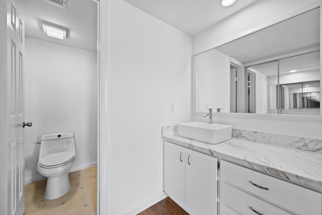 3526 Whitehall Dr Unit 106, West Palm Beach, FL 33401 - bathroom featuring toilet, vanity, baseboards, and recessed lighting