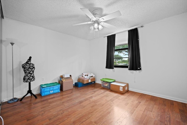 3526 Whitehall Dr Unit 106, West Palm Beach, FL 33401 - unfurnished room featuring a textured ceiling, wood finished floors, ceiling fan, and baseboards