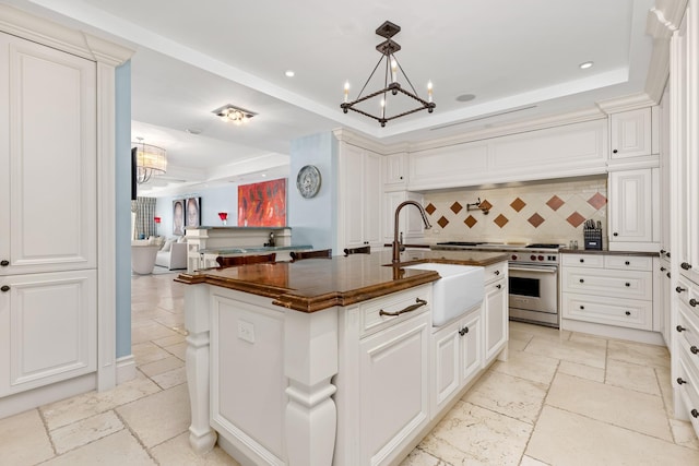 2500 S Ocean Blvd Unit Ph2, Boca Raton, FL 33432 - kitchen with a tray ceiling, a chandelier, a sink, designer range, and recessed lighting