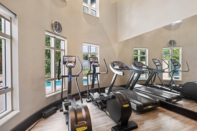 2500 S Ocean Blvd Unit Ph2, Boca Raton, FL 33432 - workout area featuring wood finished floors, a towering ceiling, and baseboards