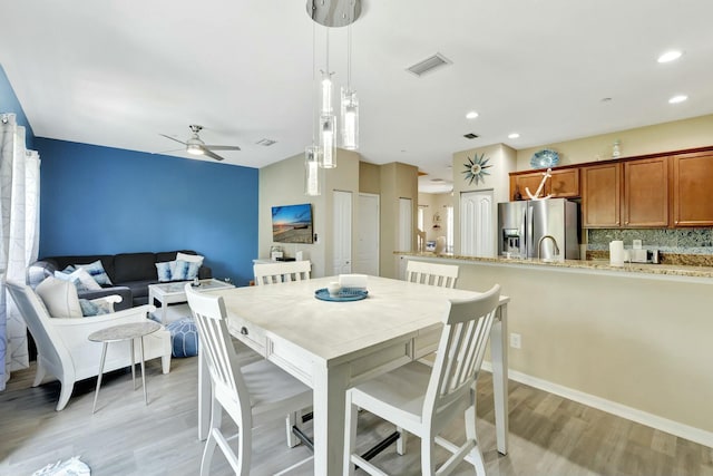 dining area featuring recessed lighting, ceiling fan, visible vents, and light wood-style flooring