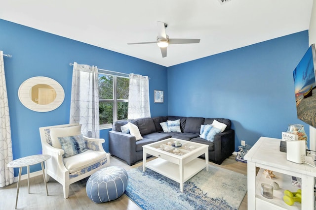 living area featuring ceiling fan and wood finished floors