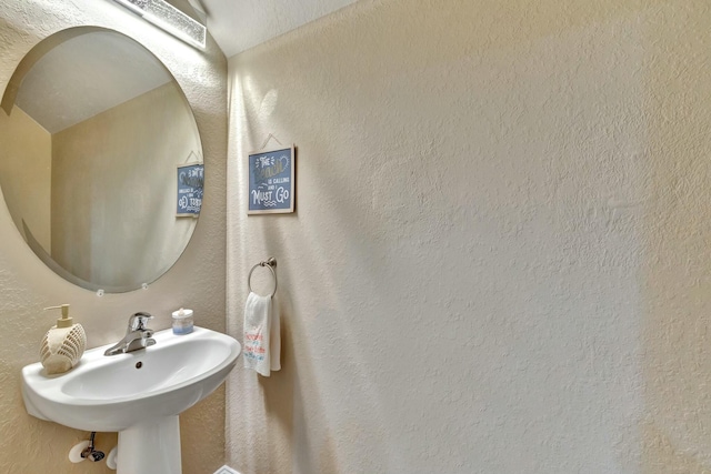 bathroom with a sink and a textured wall