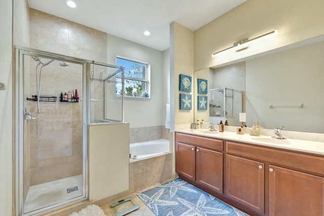 bathroom with tile patterned flooring, a sink, a bath, and a stall shower