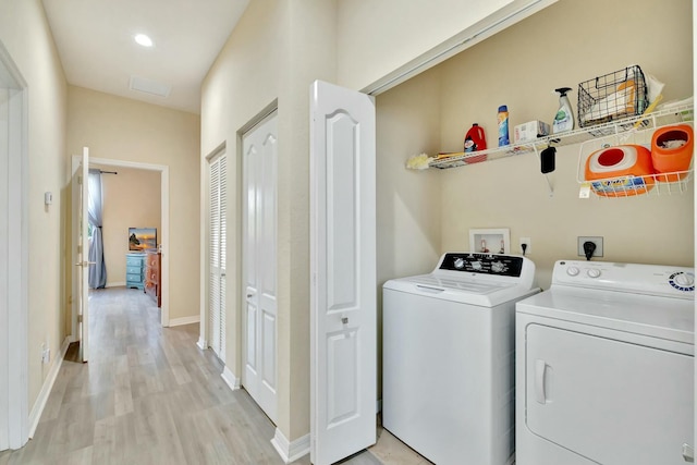 washroom featuring laundry area, light wood-style floors, baseboards, recessed lighting, and separate washer and dryer