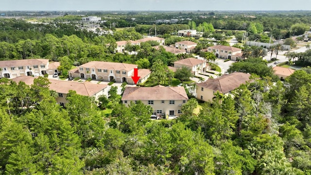 drone / aerial view with a residential view and a forest view