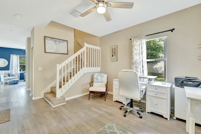 office featuring visible vents, light wood finished floors, ceiling fan, and baseboards