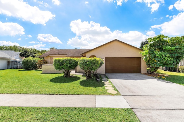 single story home featuring fence, concrete driveway, an attached garage, stucco siding, and a front yard