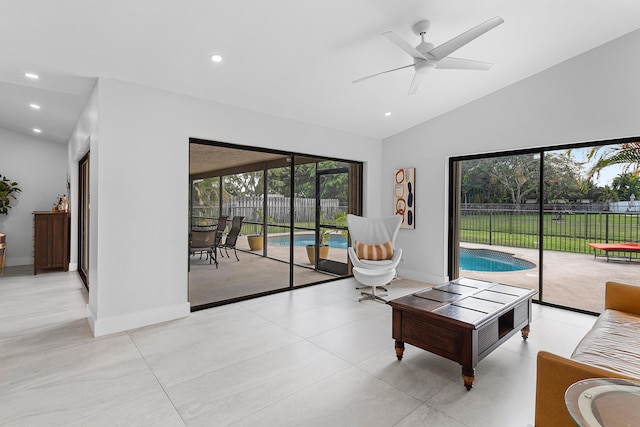 living area with lofted ceiling, a ceiling fan, baseboards, and recessed lighting