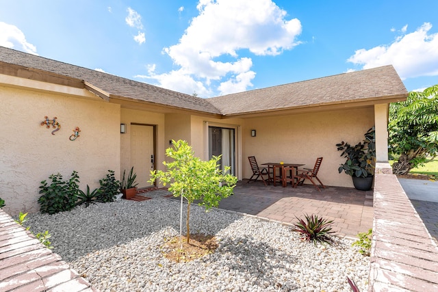 exterior space featuring a patio and stucco siding
