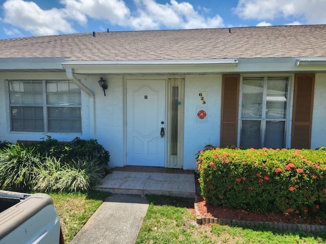 625 Pines Knoll Dr Unit B, Fort Pierce, FL 34982 - entrance to property featuring stucco siding and a shingled roof