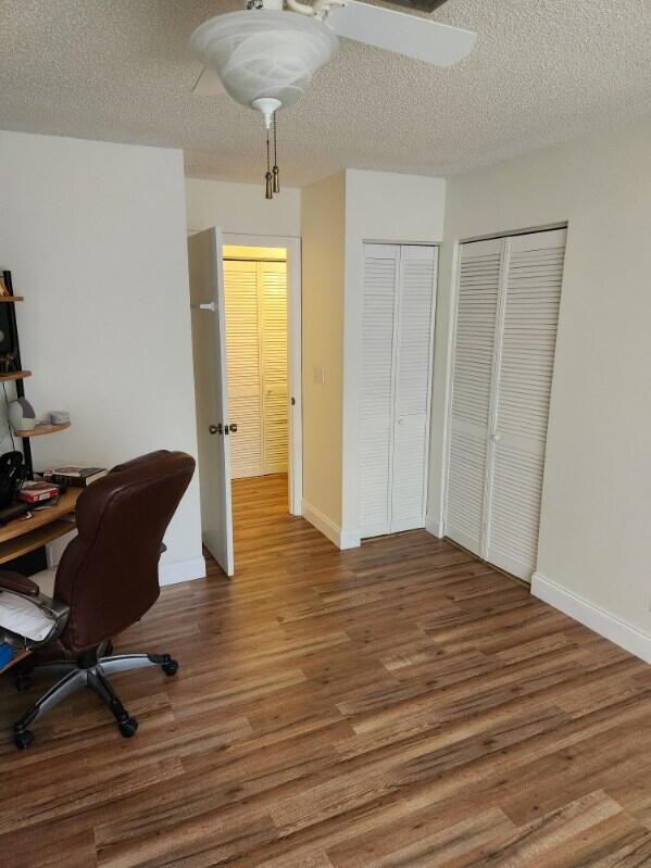 625 Pines Knoll Dr Unit B, Fort Pierce, FL 34982 - office space with wood finished floors, a textured ceiling, and baseboards
