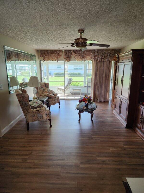 625 Pines Knoll Dr Unit B, Fort Pierce, FL 34982 - sitting room with baseboards, a textured ceiling, dark wood-style floors, and ceiling fan
