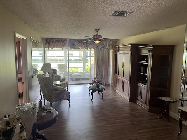 625 Pines Knoll Dr Unit B, Fort Pierce, FL 34982 - living area with visible vents, a textured ceiling, dark wood-style floors, and ceiling fan