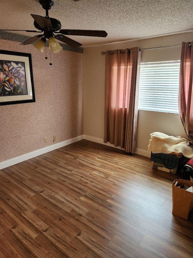 625 Pines Knoll Dr Unit B, Fort Pierce, FL 34982 - unfurnished room featuring baseboards, wood finished floors, a textured ceiling, and ceiling fan
