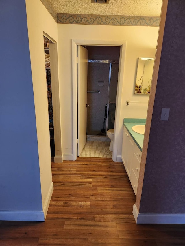 625 Pines Knoll Dr Unit B, Fort Pierce, FL 34982 - corridor with baseboards, wood finished floors, visible vents, and a sink