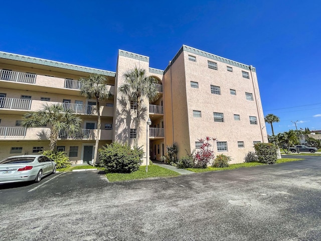 4281 NW 41st St Unit 320, Lauderdale Lakes, FL 33319 - view of apartment building / complex featuring uncovered parking