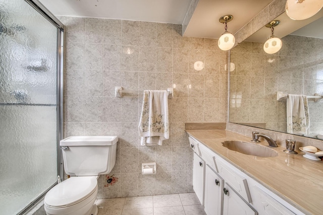 4281 NW 41st St Unit 320, Lauderdale Lakes, FL 33319 - full bathroom featuring a stall shower, vanity, tile patterned floors, toilet, and tile walls
