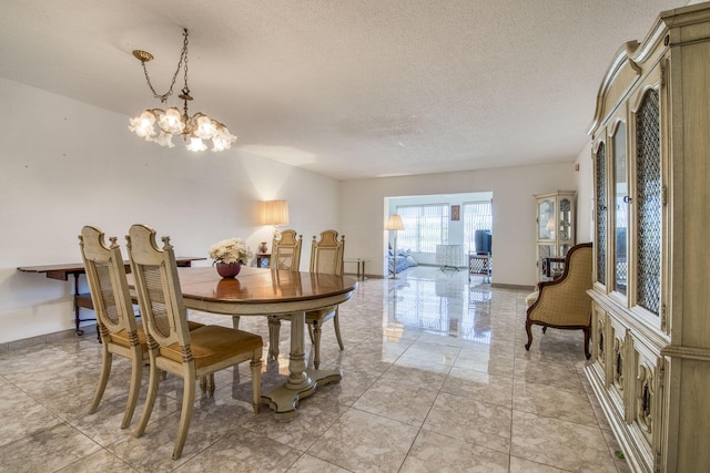 4281 NW 41st St Unit 320, Lauderdale Lakes, FL 33319 - dining area with a chandelier and a textured ceiling