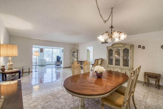 4281 NW 41st St Unit 320, Lauderdale Lakes, FL 33319 - dining space with a textured ceiling and a chandelier