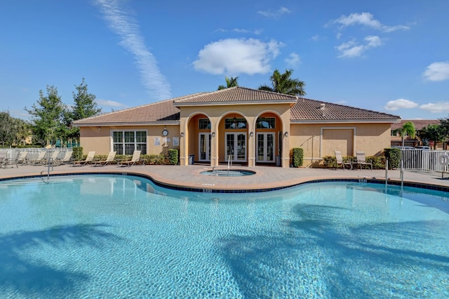 5797 Monterra Club Dr, Lake Worth, FL 33463 - pool with fence, a patio area, french doors, and a hot tub