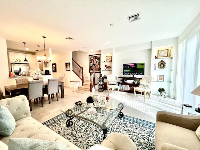 5797 Monterra Club Dr, Lake Worth, FL 33463 - living room featuring an inviting chandelier, light tile patterned flooring, stairs, and visible vents