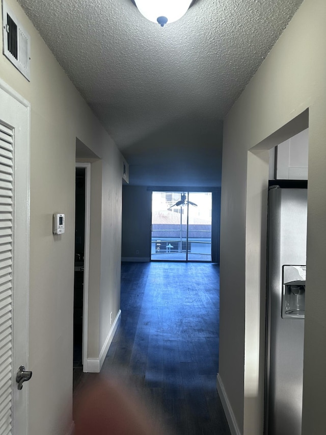 1040 SE 4th Ave Unit 222, Deerfield Beach, FL 33441 - corridor with baseboards, dark wood-style flooring, a textured ceiling, and visible vents